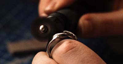 Person polishing a ring.